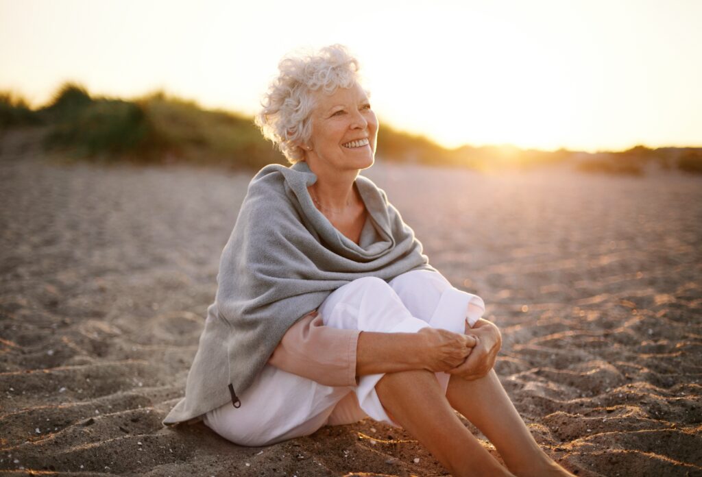 happy retired woman on a beach