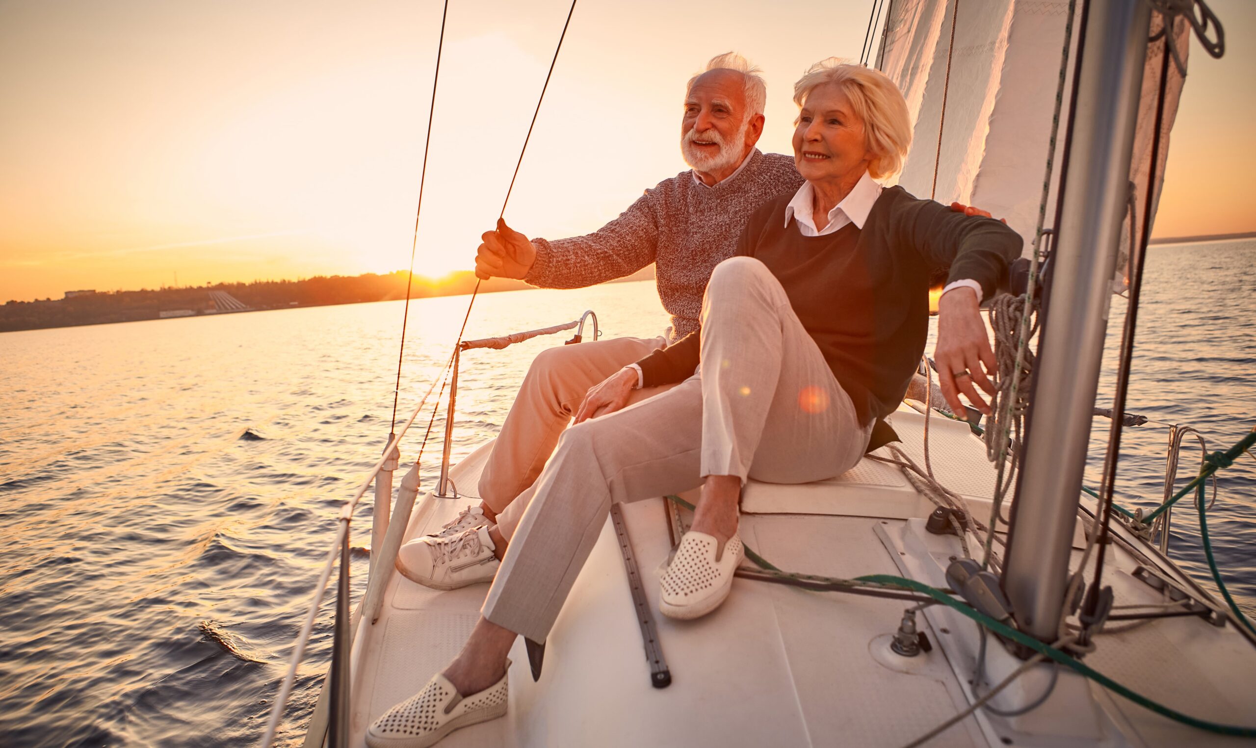 beautiful senior couple enjoying a sunset on a boat